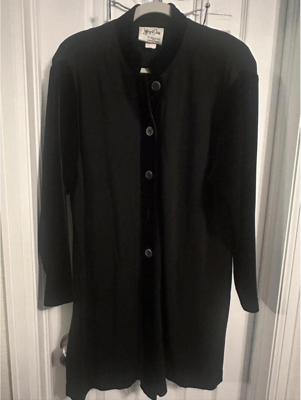 Vintage black knee length cardigan button front with velvet lapel and sleeves.